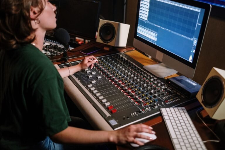 Audio engineer at a mixing desk in a recording studio