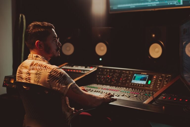 Mastering engineer working at a studio mixing console